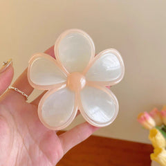 Pastel Flower Hair Clip – Translucent Daisy Design in soft pastel colors held in a hand, showcasing its delicate petals.