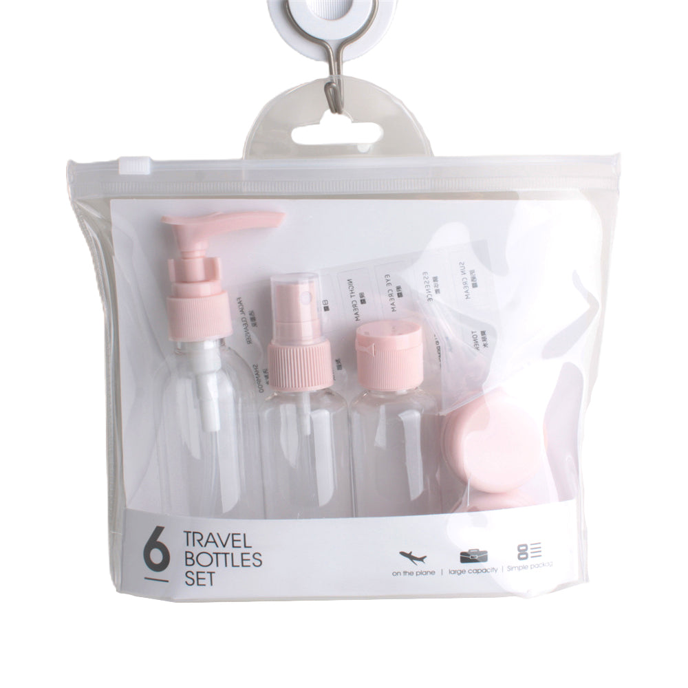 Travel Bottle Set containing six clear bottles with pink caps in a convenient travel bag.