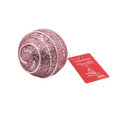 Pink glittery Christmas Ball(P) ornament with a decorative spiral design and attached tag.