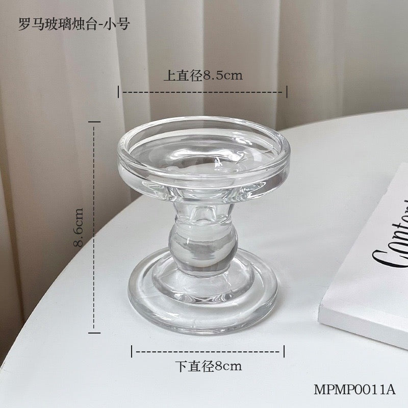 Clear glass Candle Holder S.K. with a round base and elegant design, perfect for home decor.