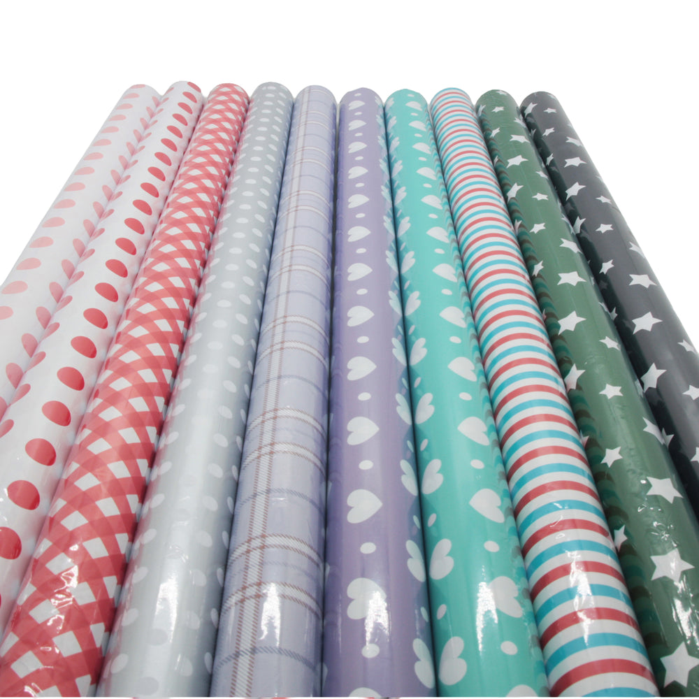 Set of rolls of patterned paper including polka dots, plaid, and stripes on a white background.