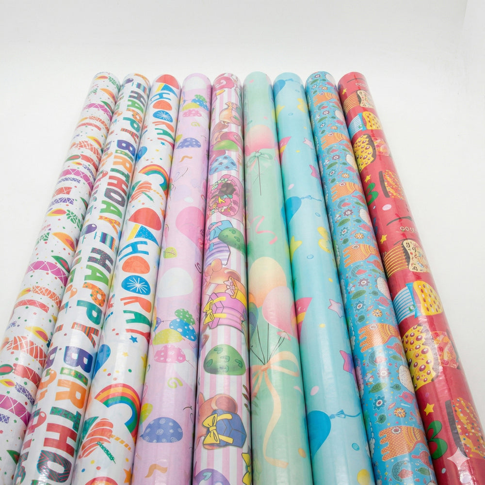 Rolls of colorful birthday-themed gift wrap paper on a white background