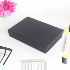 4/10 Gift Box Thin FBTX Black(40*30.5*8.3CM) displayed on a desk with flowers and office supplies.