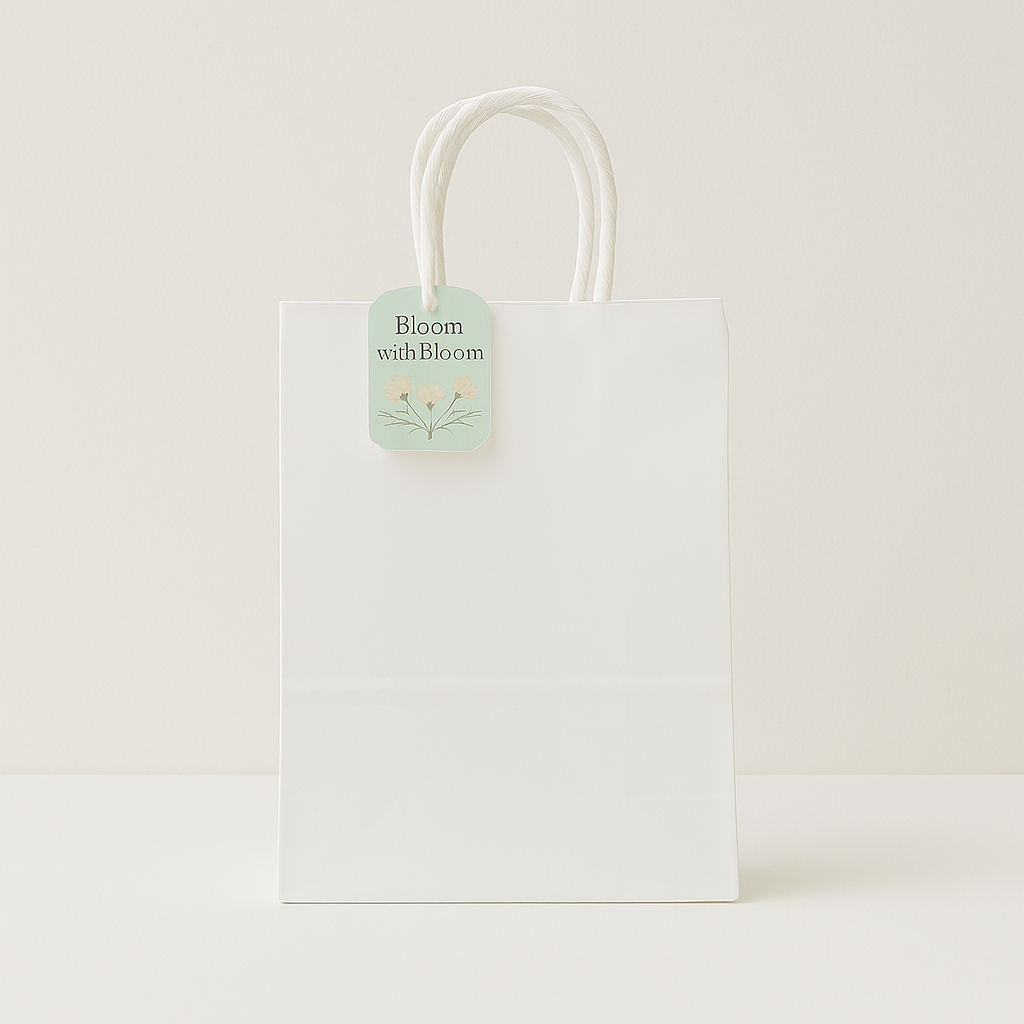 🛍️ Premium Paper Gift Bags – 4-Pack Assorted Colors (12*14*6CM) - Elegant white gift bag with floral tag and handles.