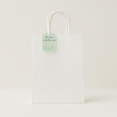 🛍️ Premium Paper Gift Bags – 4-Pack Assorted Colors (12*14*6CM) - Elegant white gift bag with floral tag and handles.