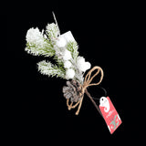 Holly White decorative sprig with pinecones and snow-like accents on a black background.