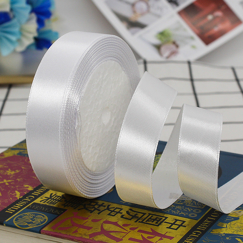 🧵 Premium Satin Ribbon – Versatile & Elegant on a crafting surface, showcasing its luxurious sheen and smooth texture.