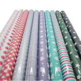 Set of rolls of patterned paper including polka dots, plaid, and stripes on a white background.