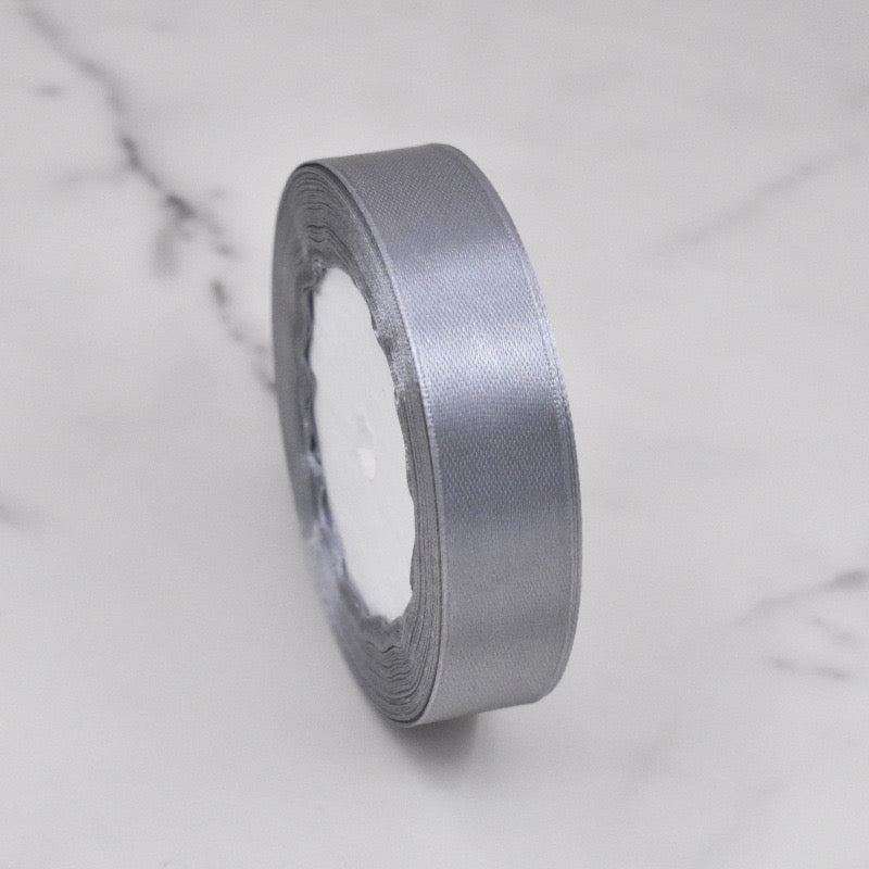 🧵 Premium Satin Ribbon – Versatile & Elegant in silver color on a marble background.