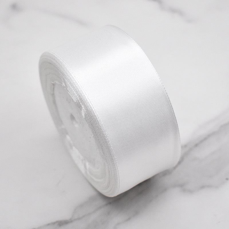 Premium Satin Ribbon – Versatile & Elegant roll on marble surface, showcasing luxurious satin finish for crafting and decorating.