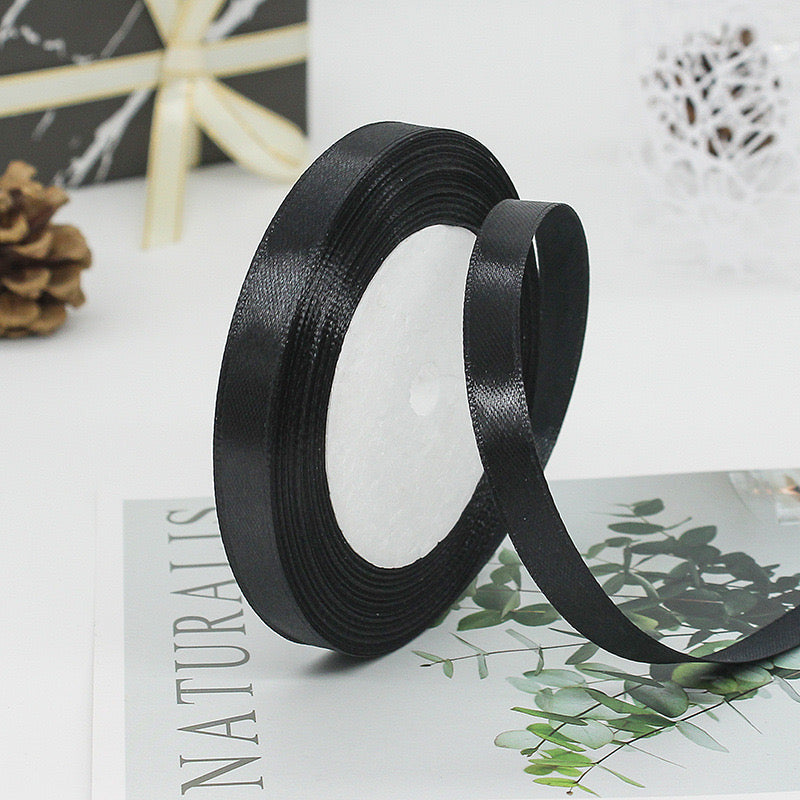 🧵 Premium Satin Ribbon – Versatile & Elegant on a crafting magazine, showcasing its luxurious texture and sheen.