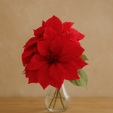 🌸 Premium Artificial Christmas Flower (Single Stem) in a clear vase adding festive charm to any setting.