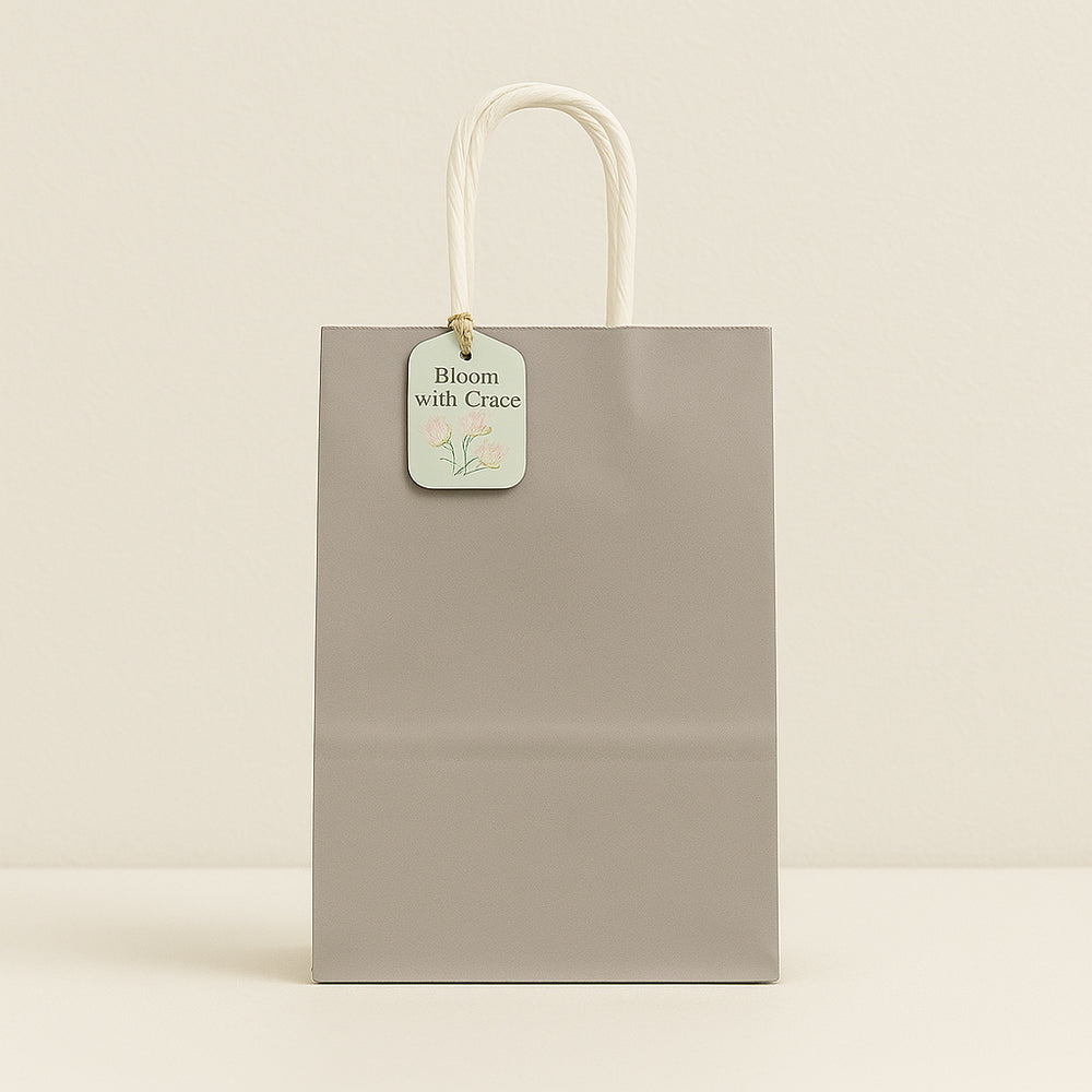 Gray gift bag with a tag on a beige background