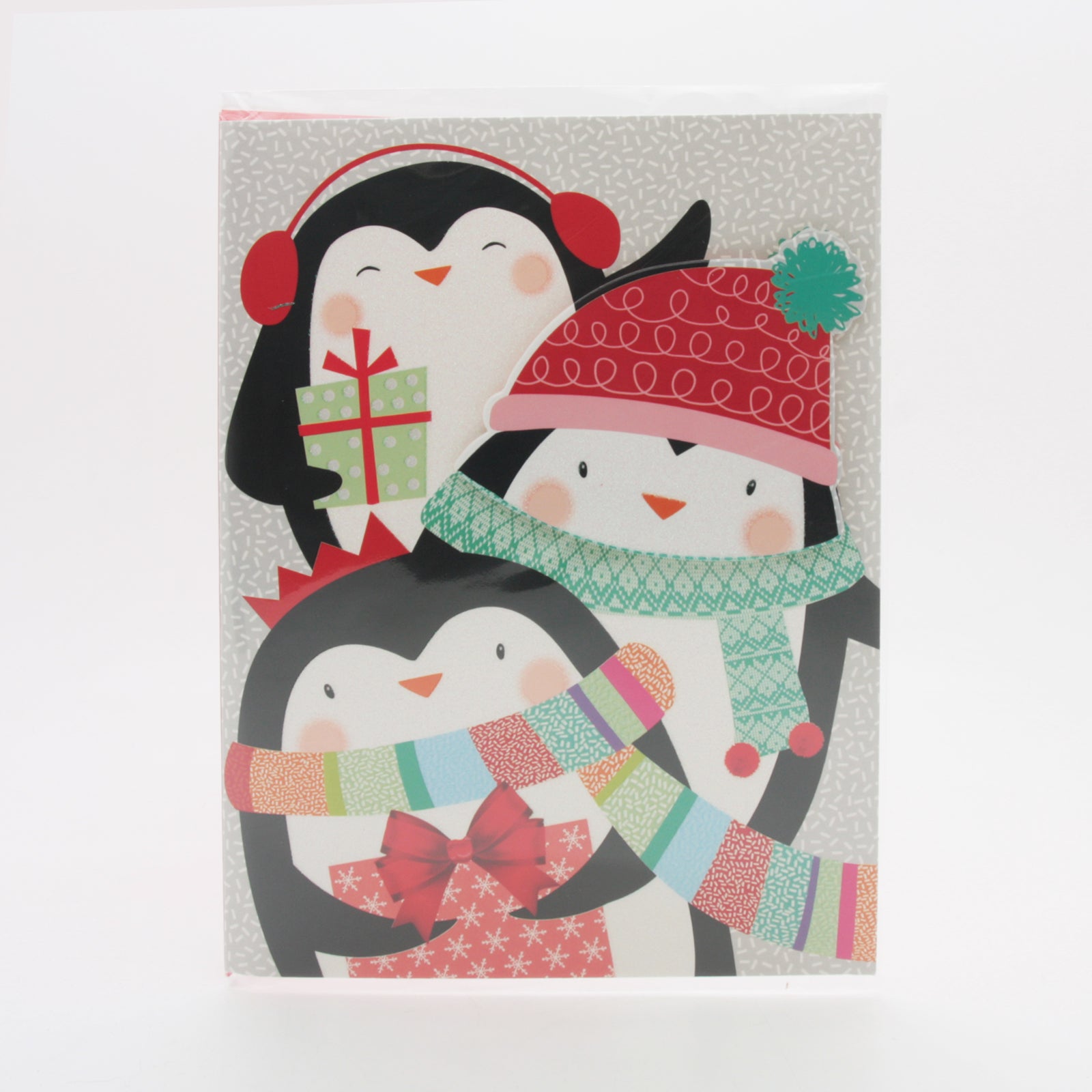 X-mas Melody Card(XC265) featuring three cheerful penguins in festive hats and scarves with a Christmas gift.