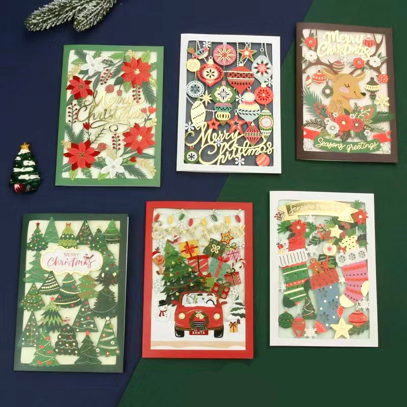 A collection of festive 3D Embellished Christmas Greeting Cards displayed on a table.