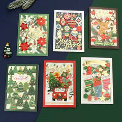 A collection of festive 3D Embellished Christmas Greeting Cards displayed on a table.