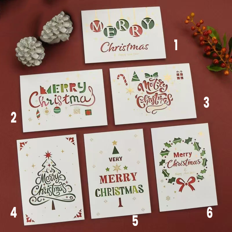 Collection of six Minimalist Christmas Greeting Cards on a flat surface surrounded by decorations.