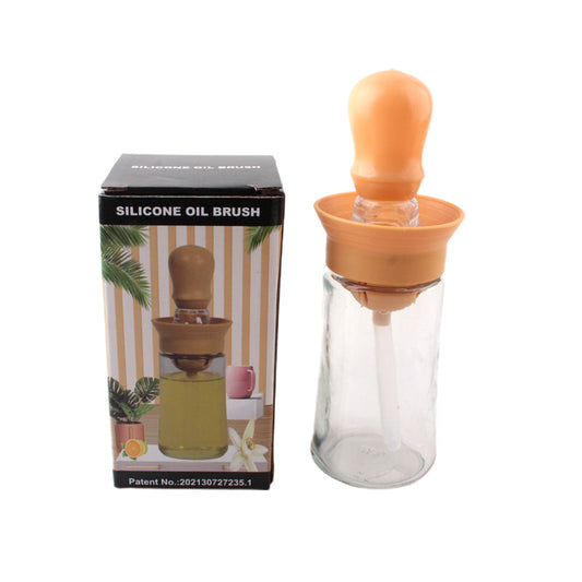 Silicone Oil Brush in a glass container with an orange silicone cap, perfect for applying oil evenly.